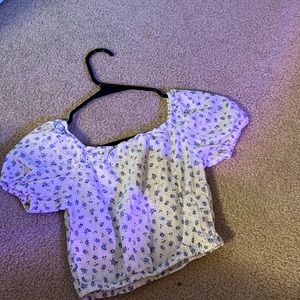 A blue flower and white cropped top